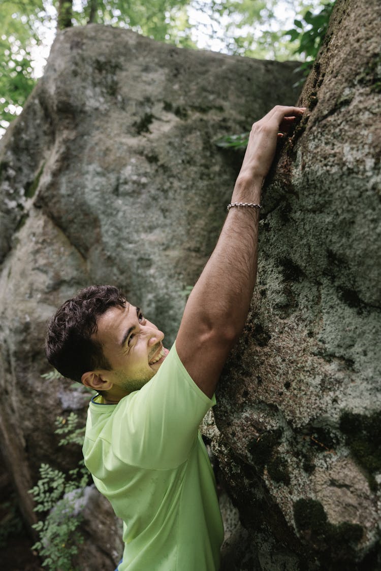 A Man Climbing A Rock