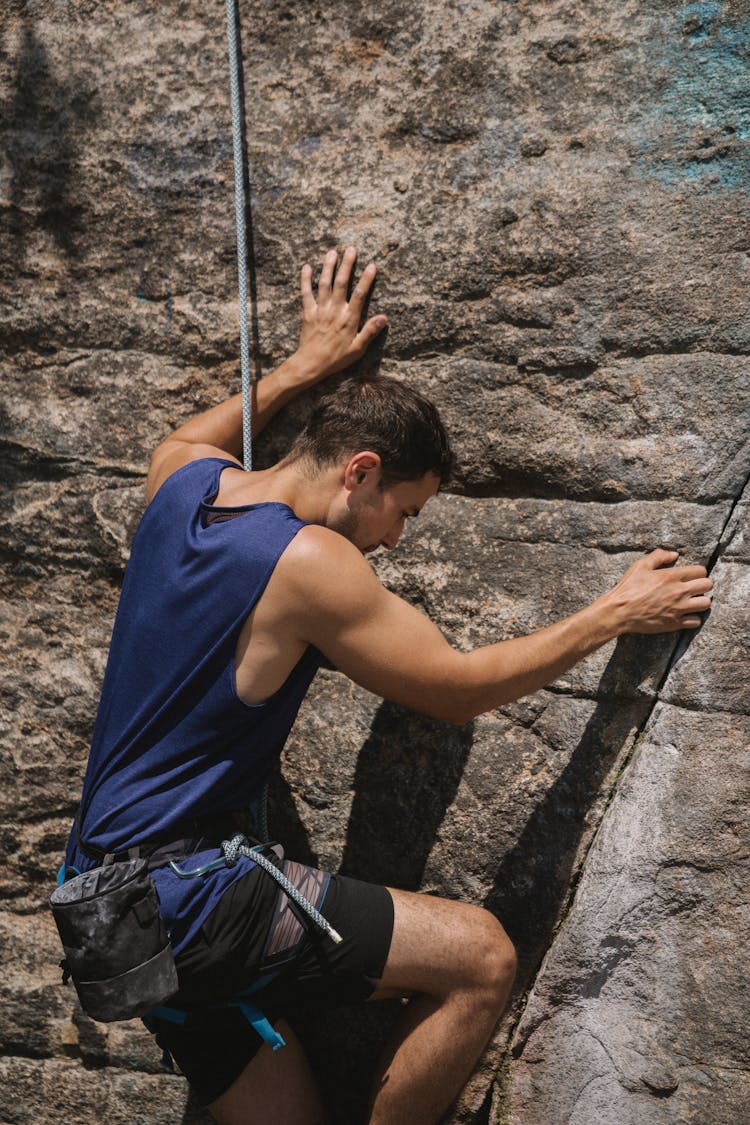 A Man Climbing A Rock