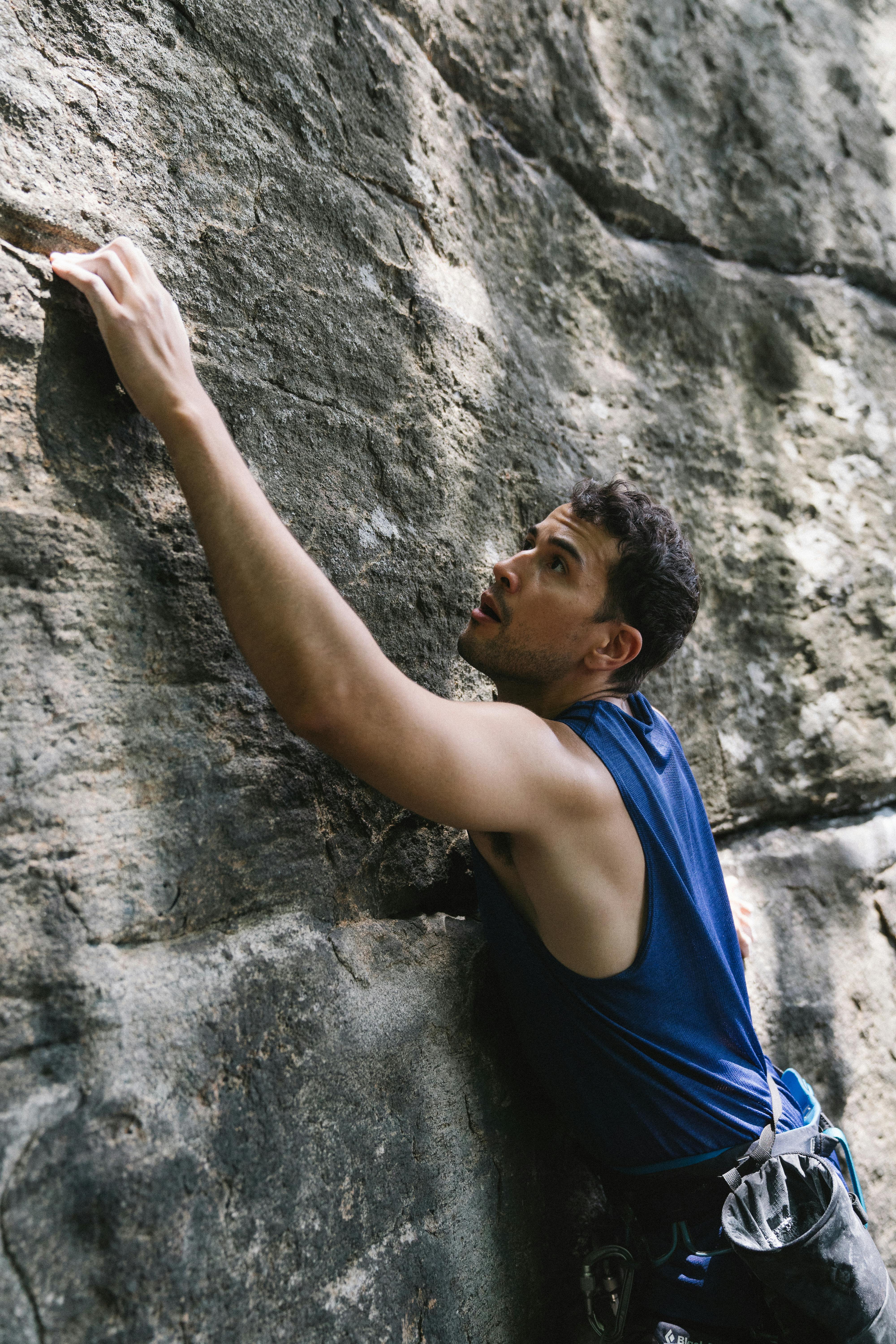 Man in Blue Tank Top Climbing Rocks · Free Stock Photo