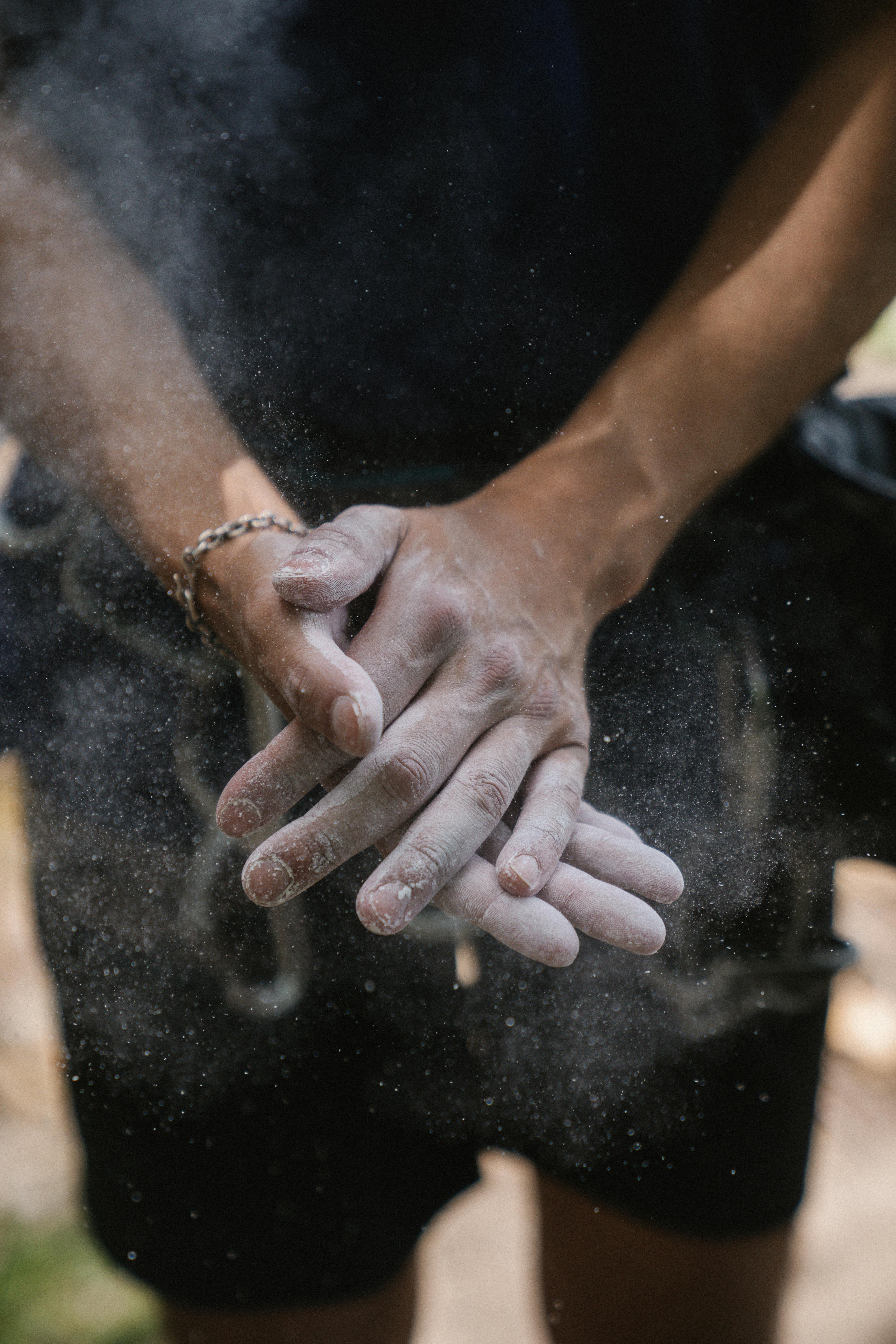 man clapping with powder on his hands