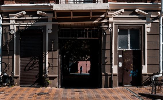 Captivating street view of an urban facade in Rostov-on-Don with sunlight casting artistic shadows.