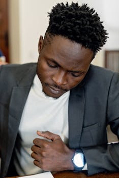 Adult man concentrating intently on documents in an office environment.