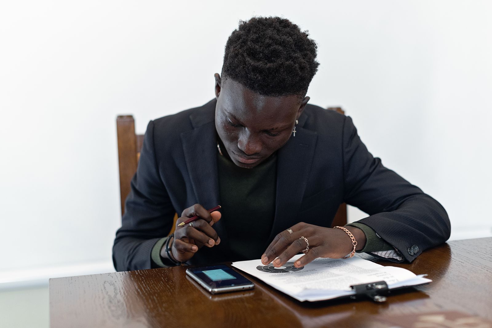 Worker reviewing documents and a smartphone in a calm workplace setting
