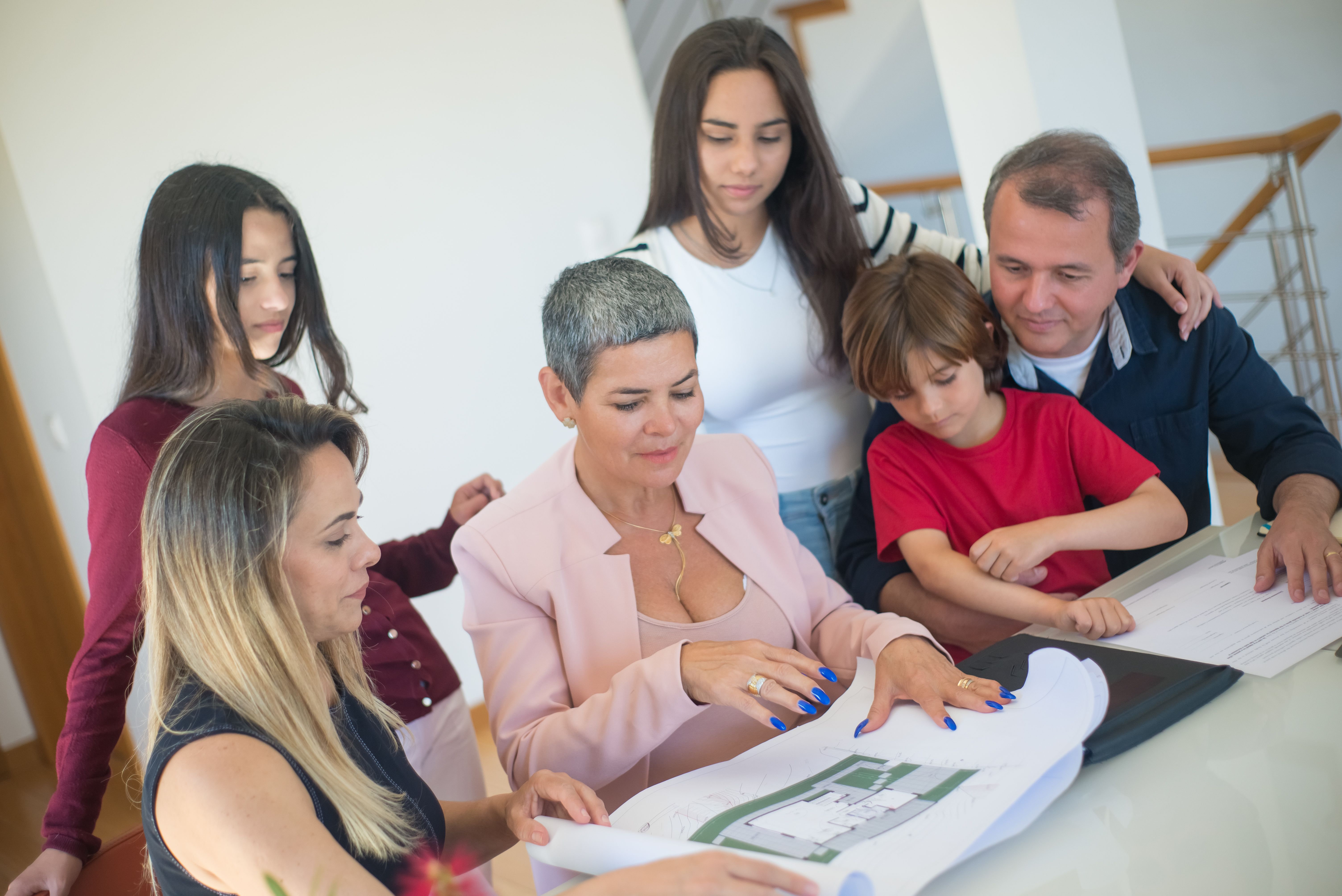 Family discussing home purchase plans with a realtor