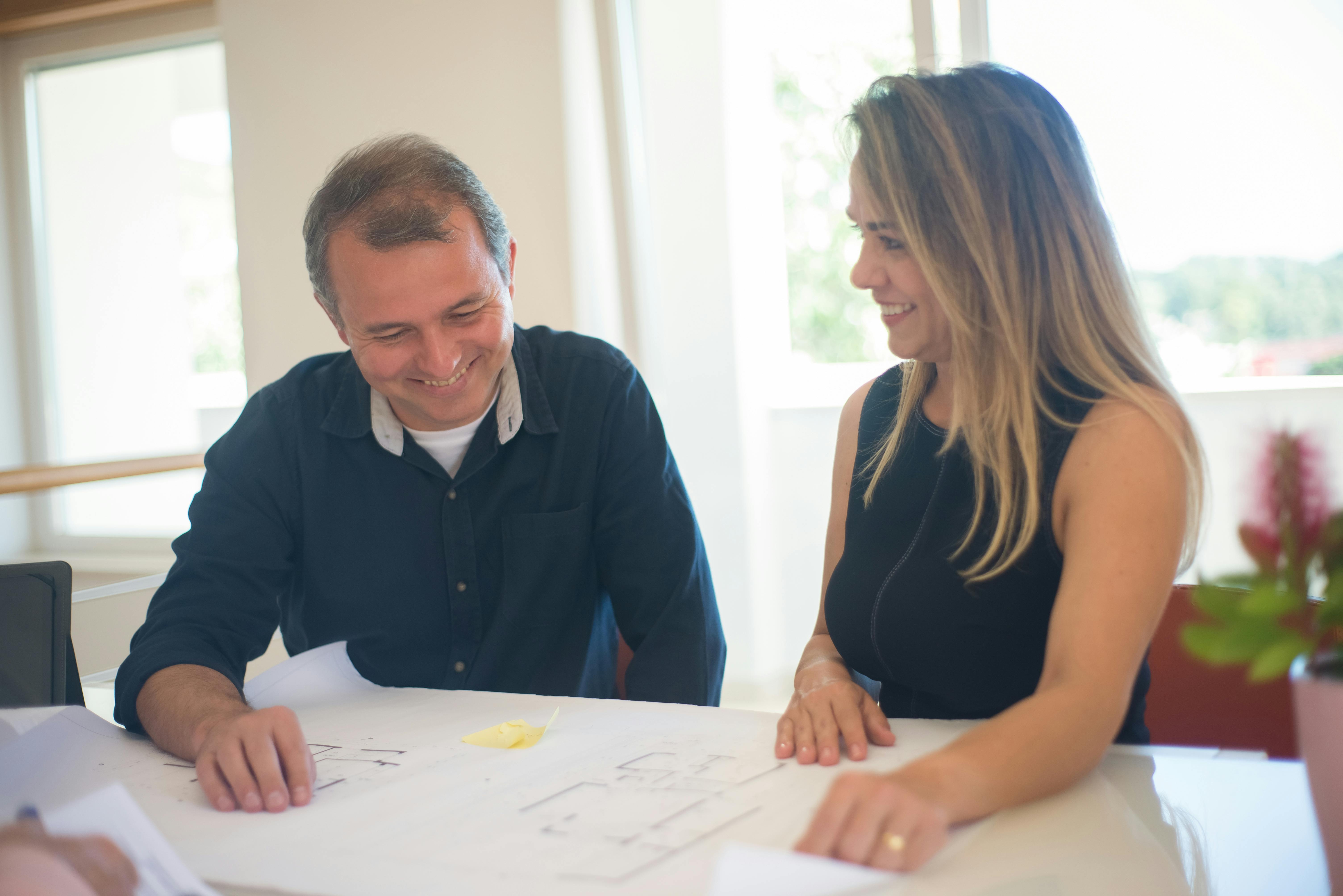 Free 

A Couple Looking at a Blueprint Stock Photo