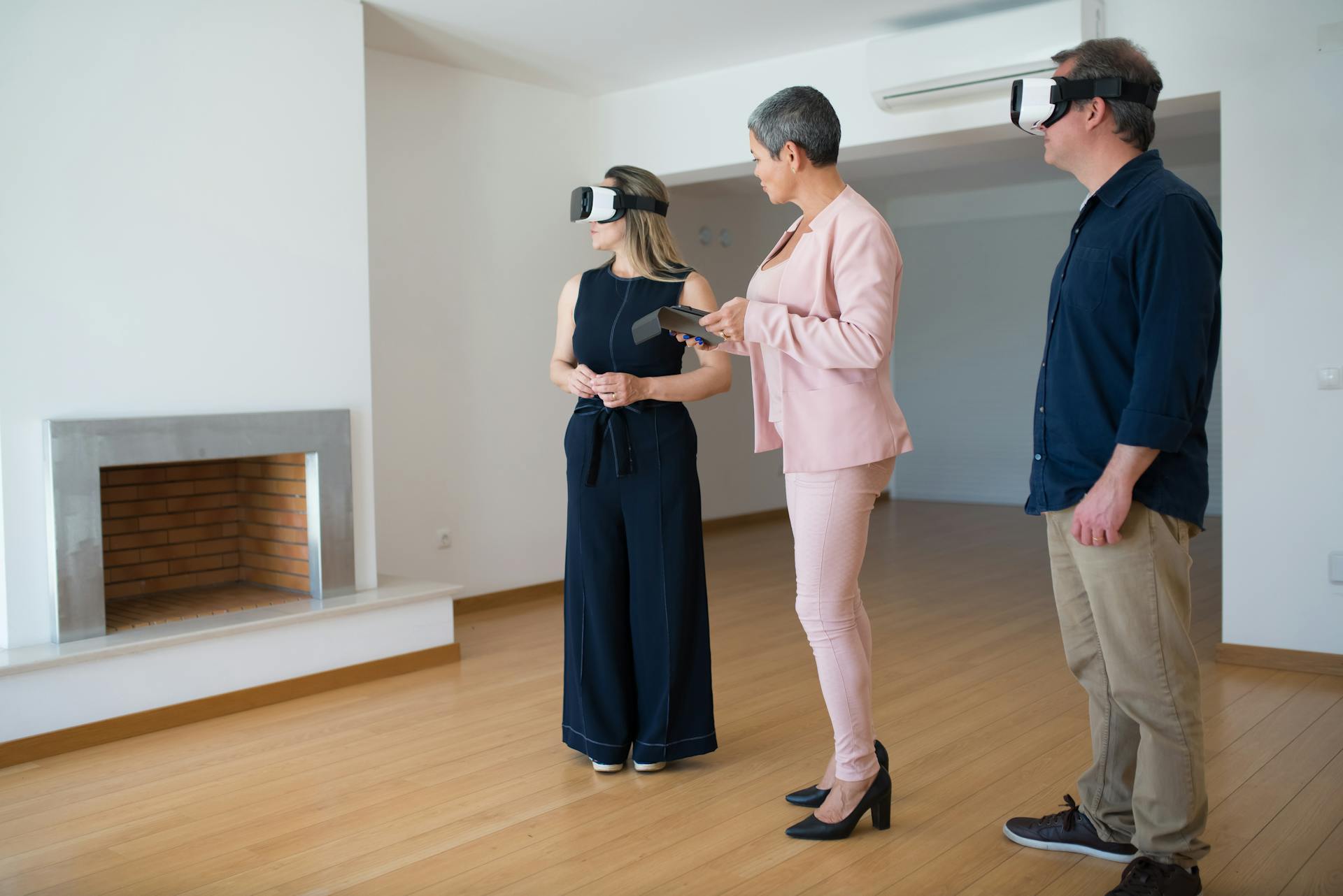 Virtual reality real estate viewing in an empty house with multiple adults.