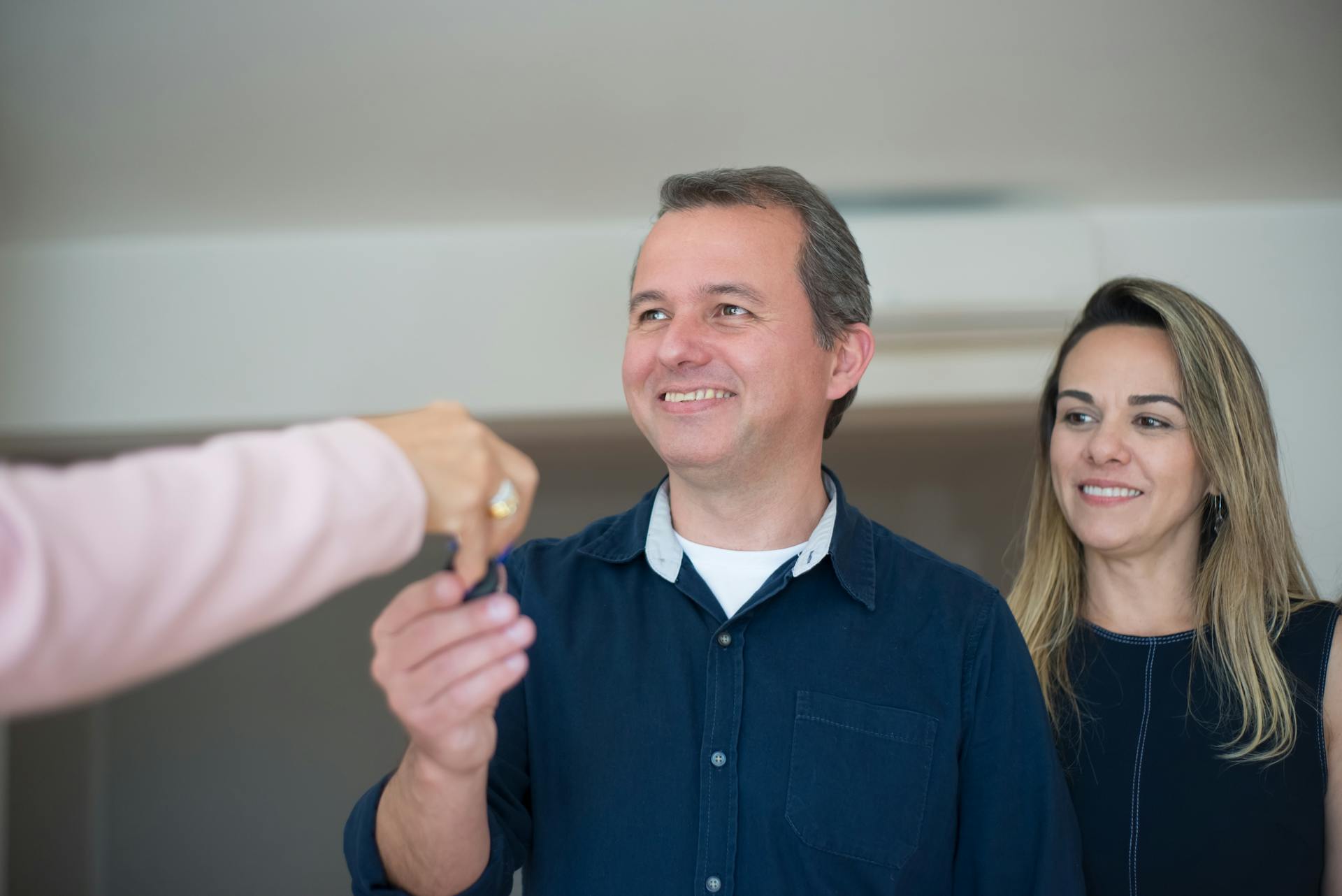 A Couple Receiving Keys from a Broker