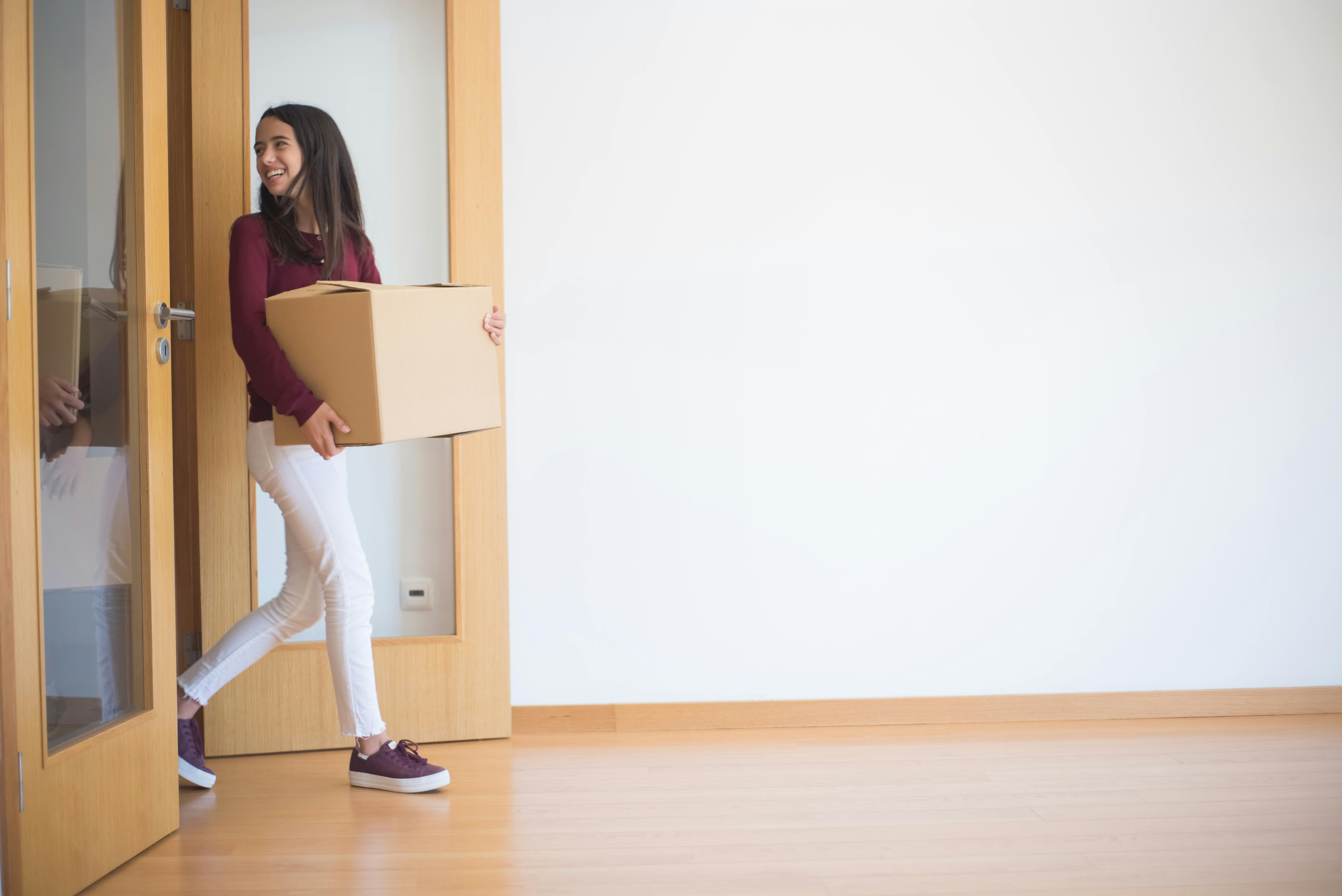 Mulher entrando em apartamento novo