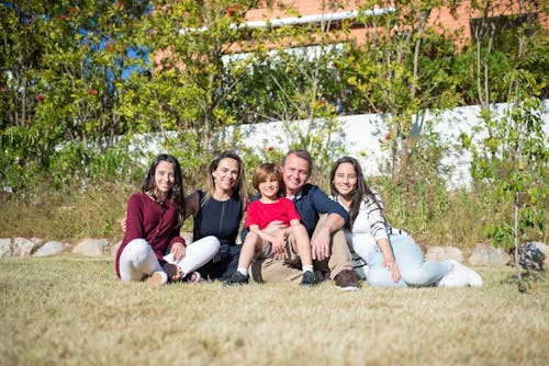 Free Family Sitting on Grass Field Stock Photo