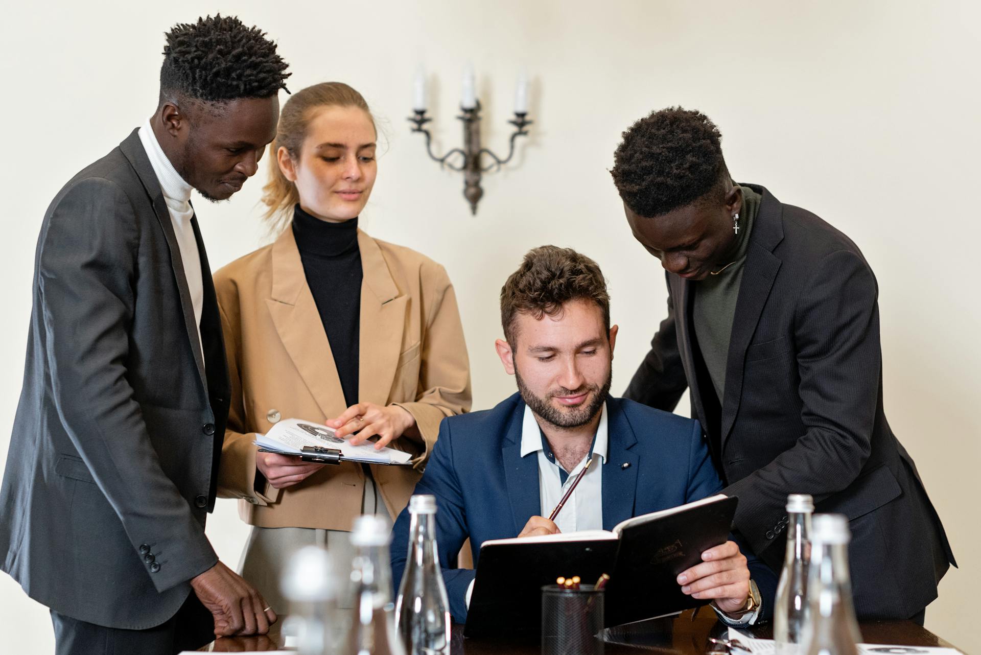 A group of professionals engaged in a collaborative business meeting in an office setting.