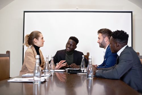 Free A diverse group of professionals engaged in a business meeting in an office setting. Stock Photo