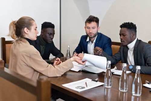Free Business team in office meeting discussing contracts with diverse representation. Stock Photo