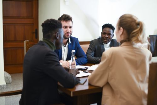 Free A diverse group of professionals having a business meeting around a table. Stock Photo