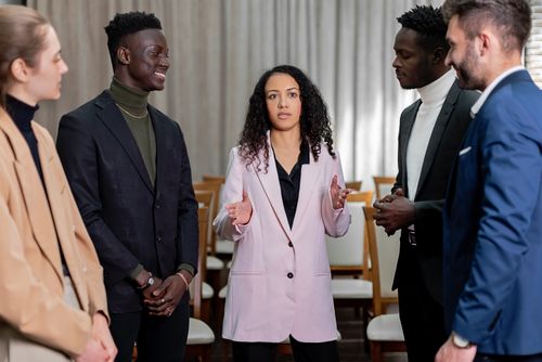 Free A diverse group of professionals in business attire discussing ideas in a meeting setting. Stock Photo