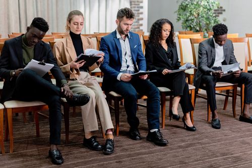 Free A diverse group of business professionals reviewing documents in a meeting setting. Stock Photo