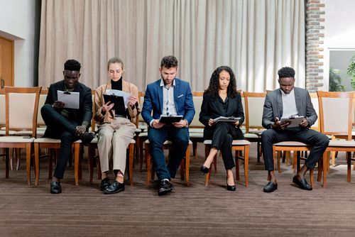 Free A diverse group of professionals attentively reviewing documents indoors. Stock Photo