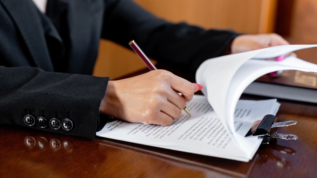 Professional signing a legal agreement representing music licensing negotiations