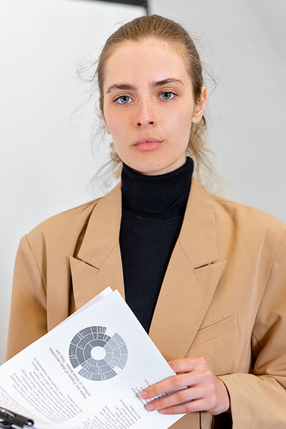 Portrait of a professional holding documents. Stock photograph.
