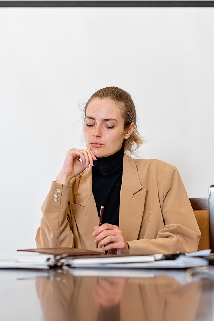 A Woman Thinking In The Office