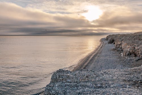 A Rocky Shoreline Under a Cloudy Sky