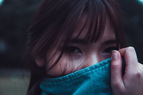 Free Woman With Brown Hair Covering Face With Blue Denim Coat Stock Photo