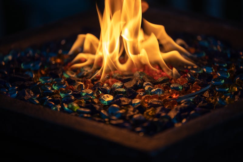 Flames dancing on a decorative glass fire pit