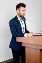 Man in Blue Suit Jacket Holding Book