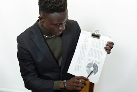 Professional businessman presenting financial report using a clipboard, highlighting important data.