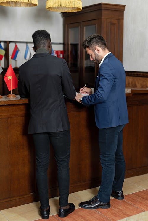 Elegant Men Signing Documents 