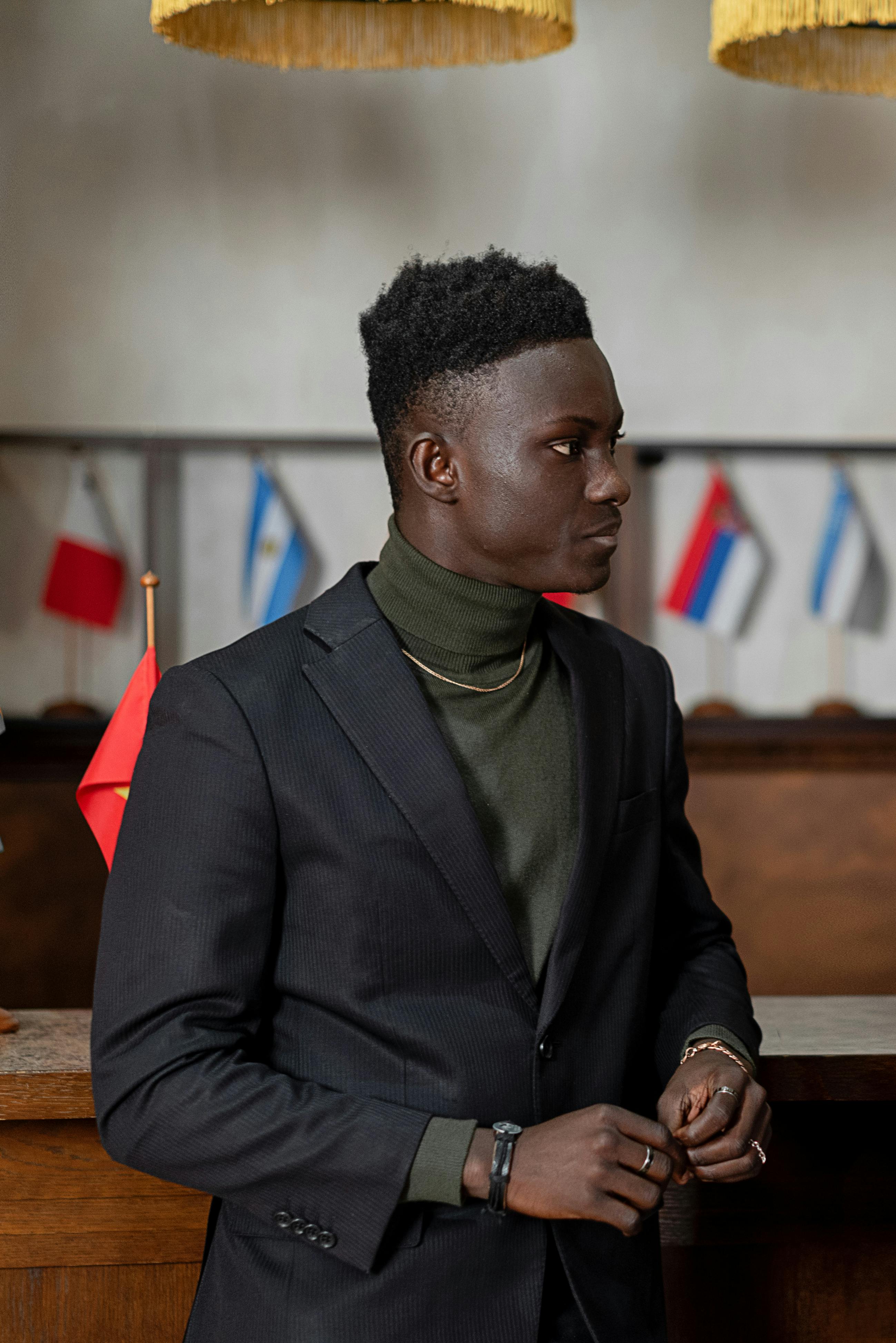 Man Wearing Black Suit Jacket over a Green Turtleneck Shirt · Free Stock  Photo