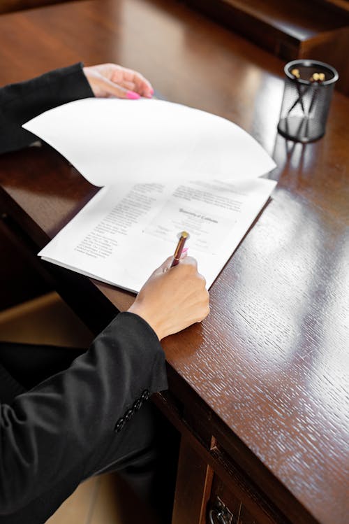 Free 
A Person Signing a Document Stock Photo
