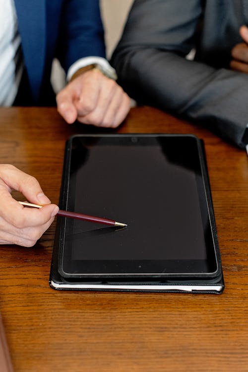 Free 

A Close-Up Shot of a Person Pointing on a Digital Tablet using a Pen Stock Photo