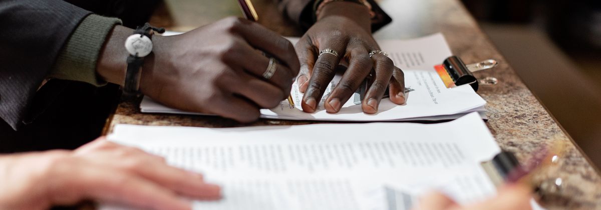 Signing legal documents at a desk