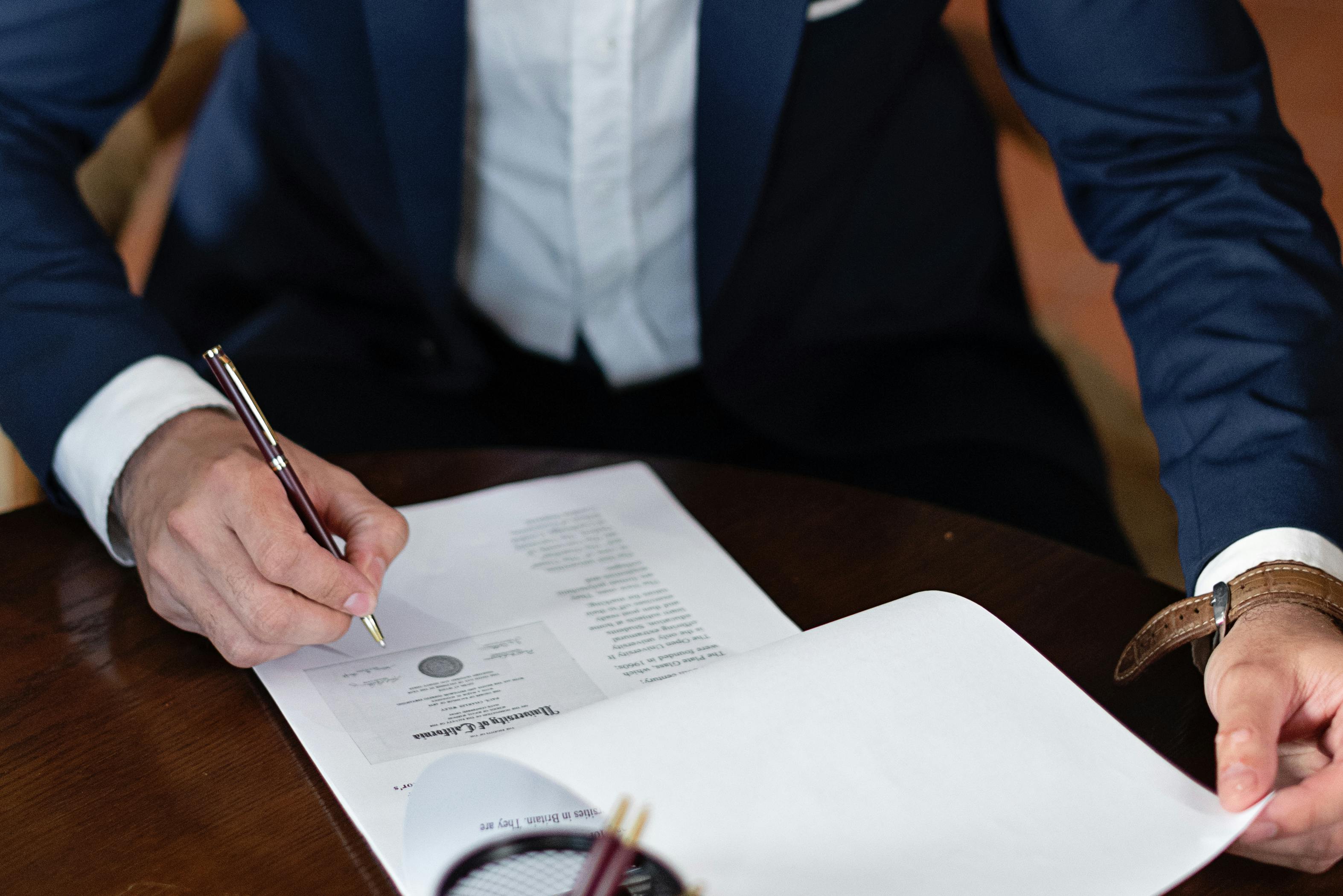 elegant man signing documents