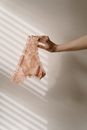 Person Holding Pink and White Floral Panty