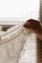 Close-Up Shot of a Person Holding a White Undies