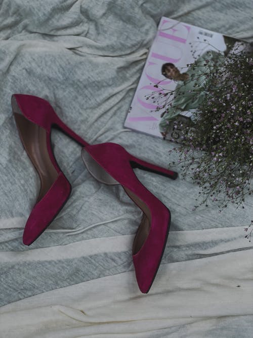 High Heeled Shoes beside a Magazine