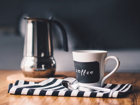 Free stock photo of coffee, cup, mug, spoon. image used for tip to make your coffee at home in my Small Ways to Save Money