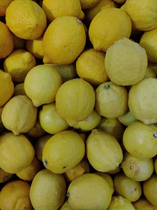Free A vibrant close-up of fresh organic lemons stacked together showcasing their bright yellow color. Stock Photo