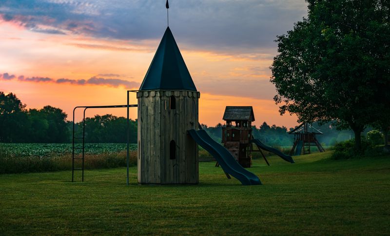 Playground slides and towers at sunset