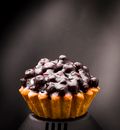 Brown Cupcake With Black and White Icing on Top
