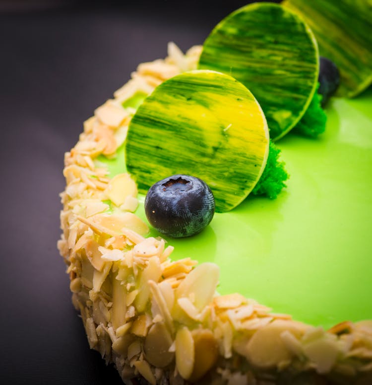 Close-up Shot Of A Green Cake With Toppings