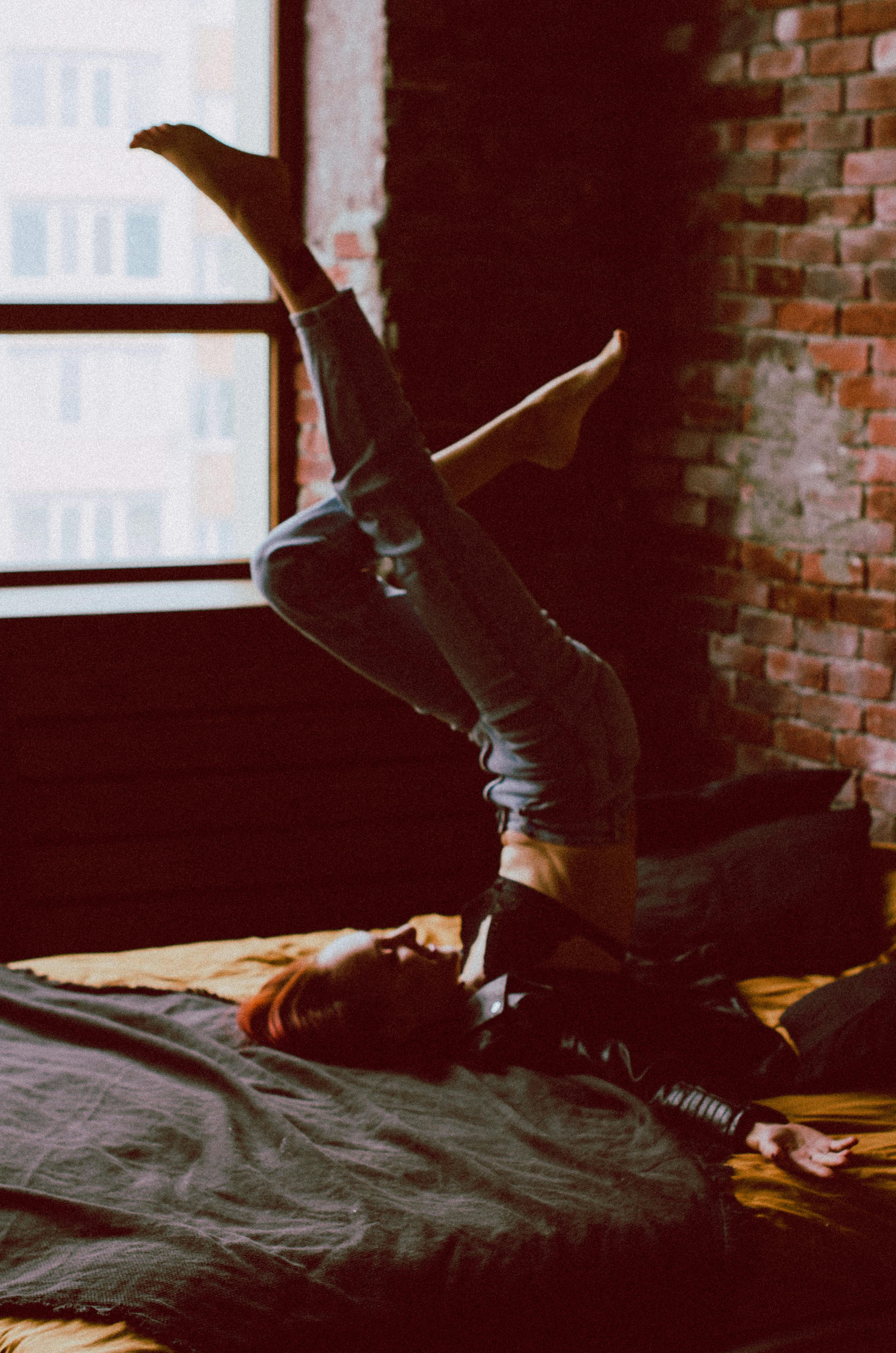 Woman Lying Down with Legs Raised · Free Stock Photo