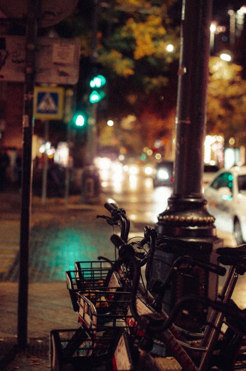 Bicycles on a Sidewalk at Night 