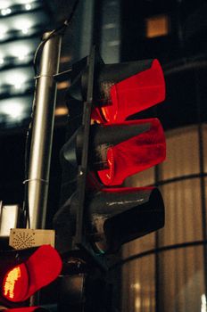 Close-up of a red traffic light at night in Krasnodar, Russia, highlighting urban night life.