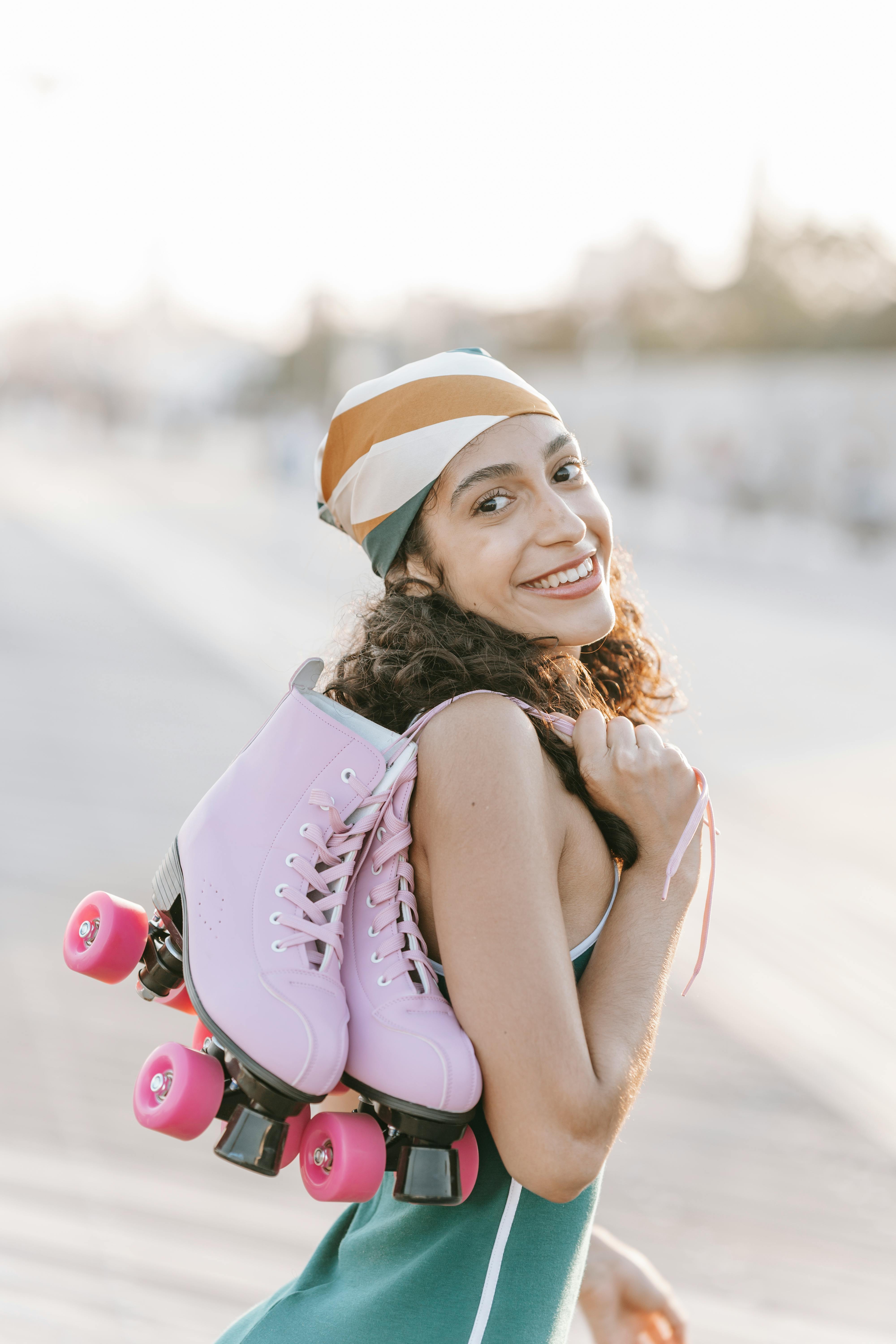 A Woman Carrying roller Skates over Her Shoulder · Free Stock Photo