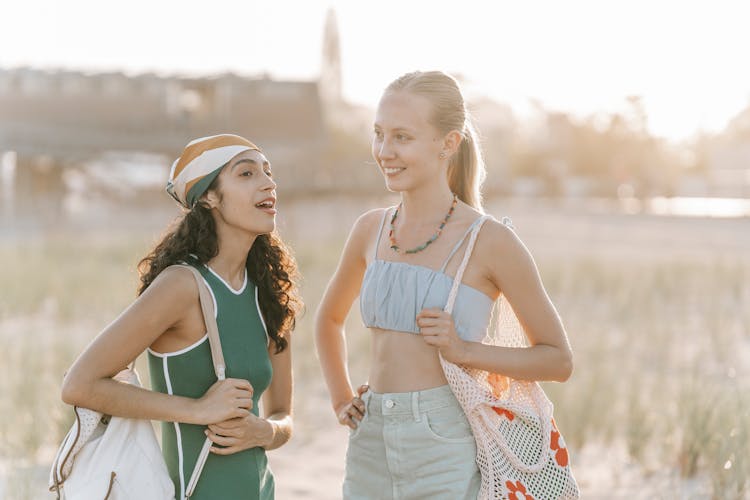 Women Talking In Sunny Field