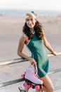 A Woman in a Swimwear Holding Roller Skates