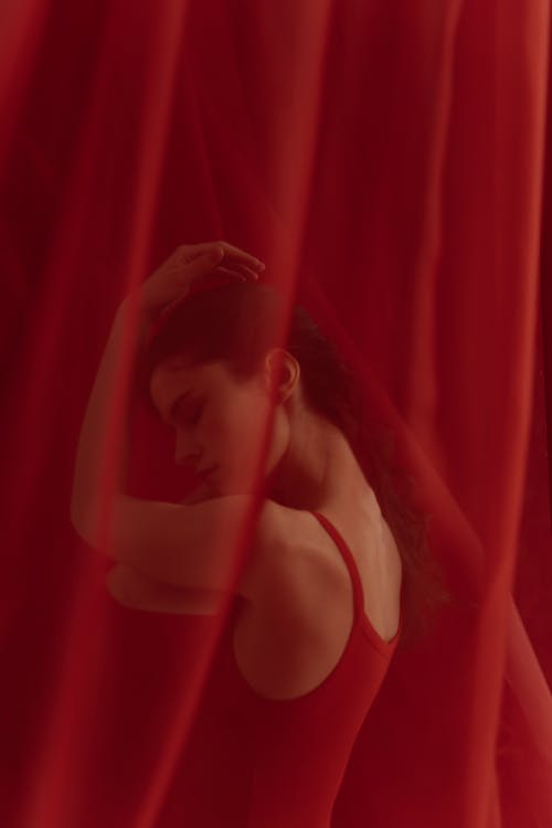 A Woman Posing with Red Curtain