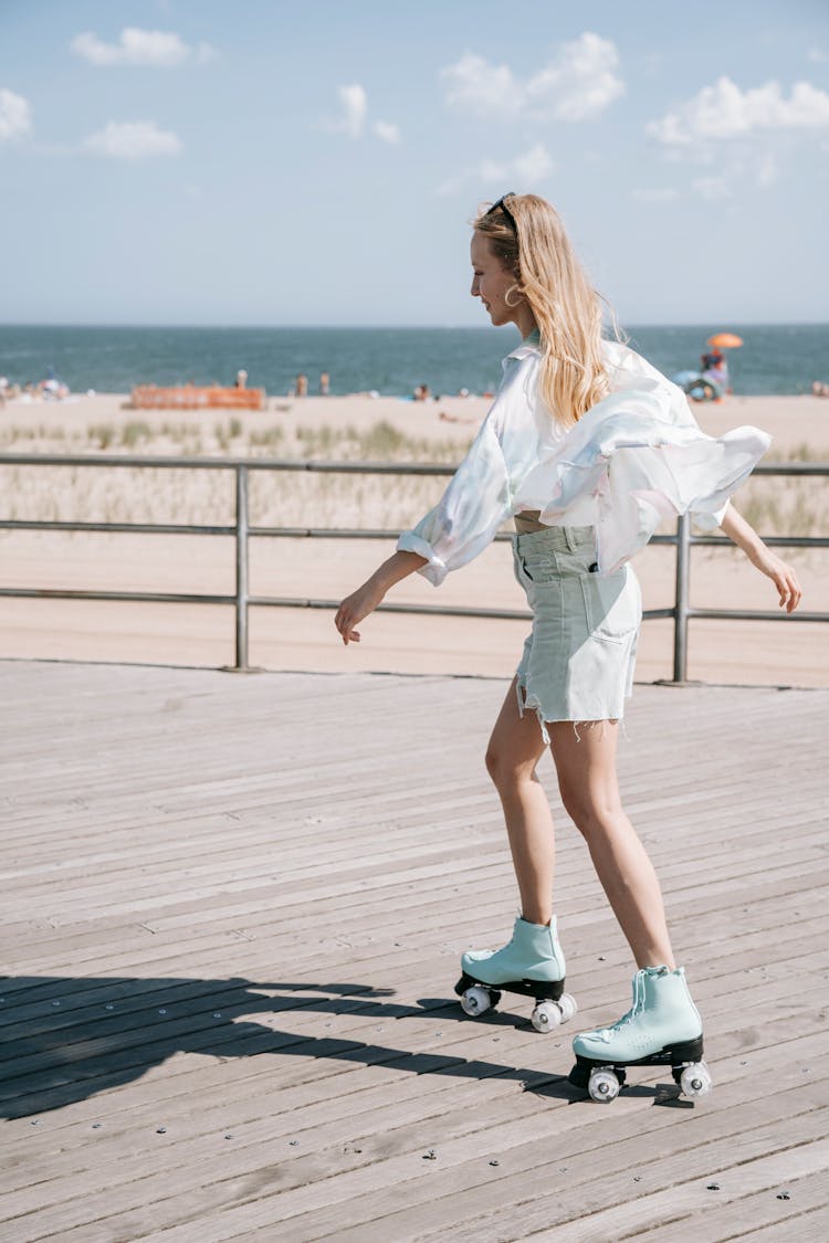 Woman Riding On Roller Skates Across Pier